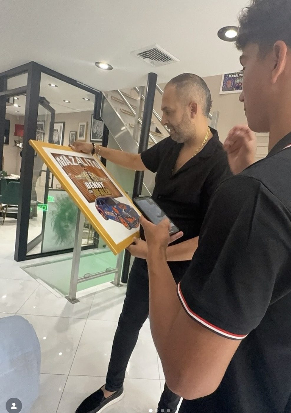 A recipient viewing a custom framed car artwork with Jacob